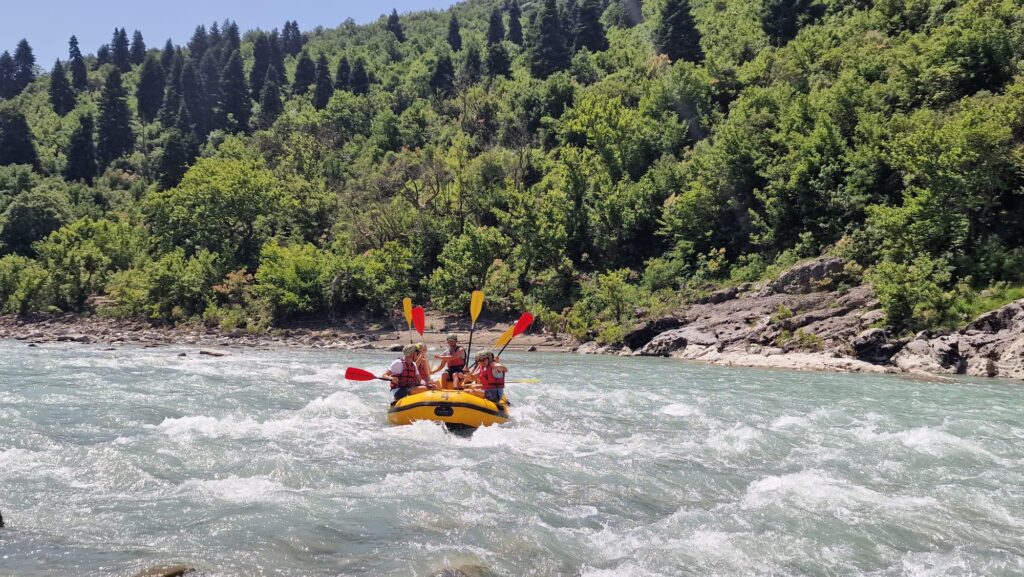 Rafting team conquering Class III rapids on the wild Vjosa River Albania