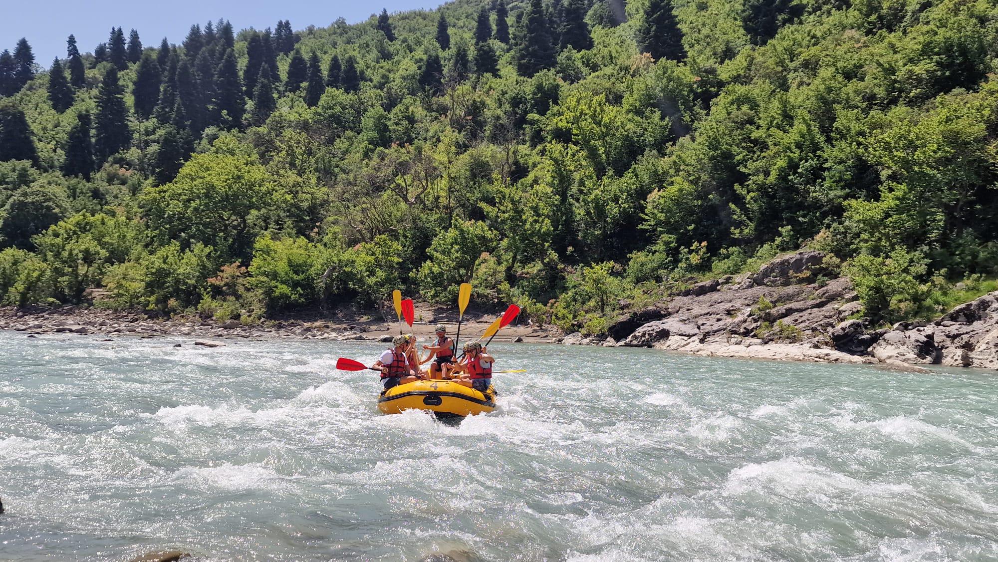 Rafting team conquering Class III rapids on the wild Vjosa River Albania